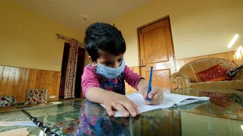 Masked School students are doing home work in home in covid-19 Stock Photos
