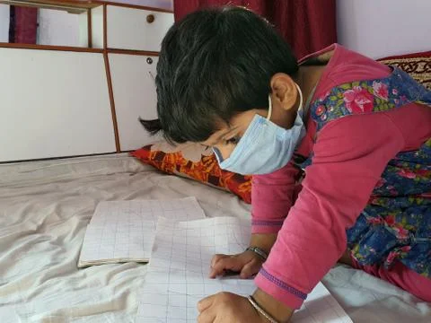 Masked School students are doing home work in home in covid-19 Stock Photos