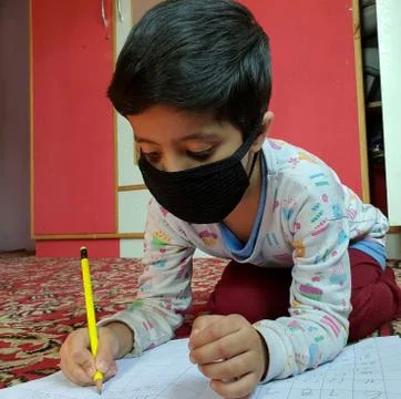 Masked School students are doing home work in home in covid-19 Stock Photos