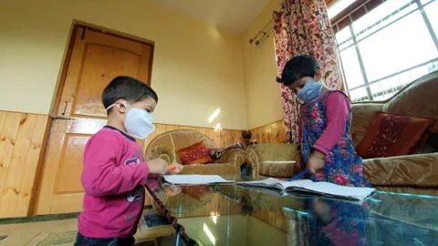 Masked School students are doing home work in home in covid-19 Stock Photos