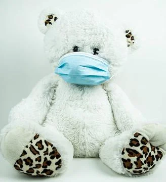 Masked teddy bear on white background Masked teddy bear with surgical mask... Stock Photos