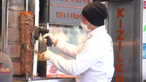A masked worker who cuts doner in corona days Stock Footage 148467583