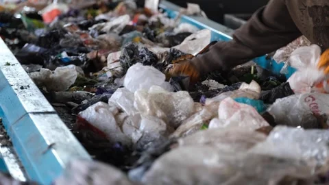 Masked workers sorting garbage on recycling belt Stock Footage 294018525
