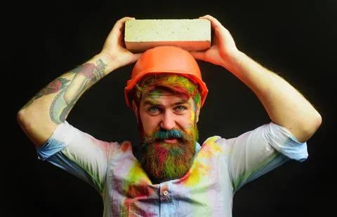 Mason bricklayer with brick. Man builder bricklayer in orange hard hat and dy Stock Photos