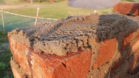 A Mason bricklayer installing bricks on construction site. Stock Footage 221257512