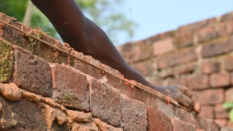 A Mason bricklayer installing bricks on construction site. Stock Footage 321034672