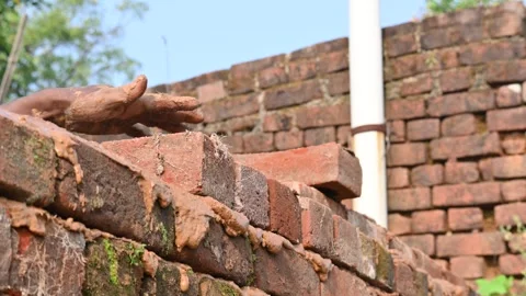 A Mason bricklayer installing bricks on construction site. Stock Footage 321035073