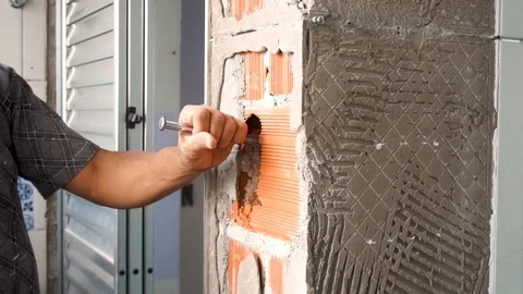 Mason is hammering wall for construction work. Stock Footage 102452481