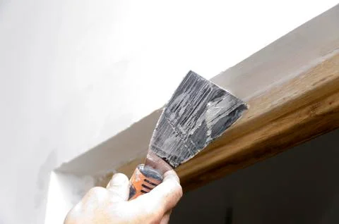 Mason hand applying plaster Stock Photos