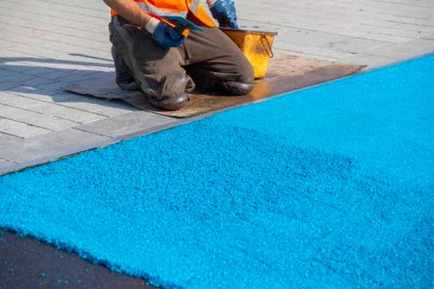 Mason spreading rubber coating Stock Photos