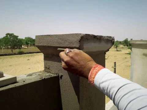 A mason at work making cement design on wall Stock Photos