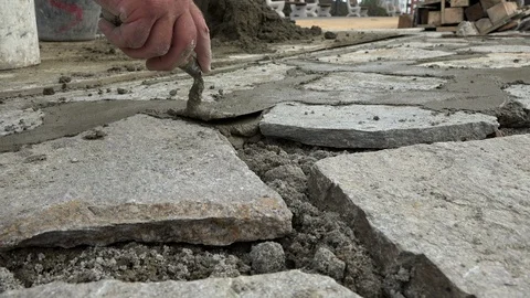 Mason worker making sidewalk pavement with stone blocks Stock Footage 96385850