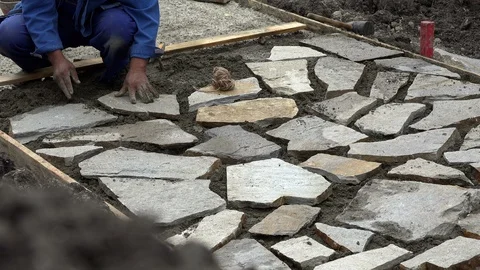 Mason worker making sidewalk pavement with stone blocks Stock Footage 96386071