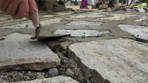 Mason worker making sidewalk pavement with stone blocks Stock Footage 96386801