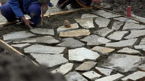 Mason workers making sidewalk pavement with stone blocks Stock Footage 96387849