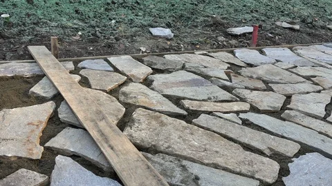Mason workers making sidewalk pavement with stone blocks Stock Footage 97217164