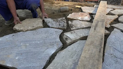 Mason workers making sidewalk pavement with stone blocks Stock Footage 97217977