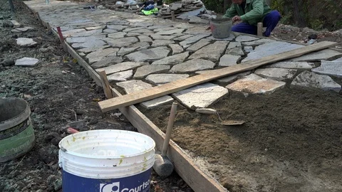 Mason workers making sidewalk pavement with stone blocks Stock Footage 97218208