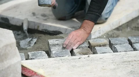 Mason working with cobblestone Video stock 64191759