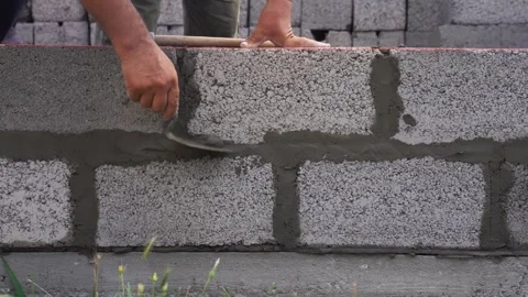 Masonry of concrete blocks and leveling of mortar Stock Footage 321748043
