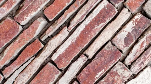 Masonry made of flat uneven red stones, wall with traces of red paint rotat.. Stock-Footage 256326115