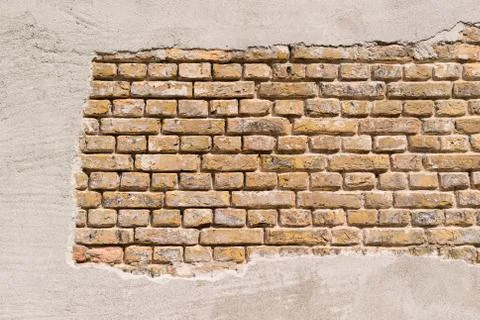 Masonry in a so-called standing brick bond with stucco. Stock Photos