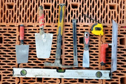 Masonry tools on a red brick. Stock Photos