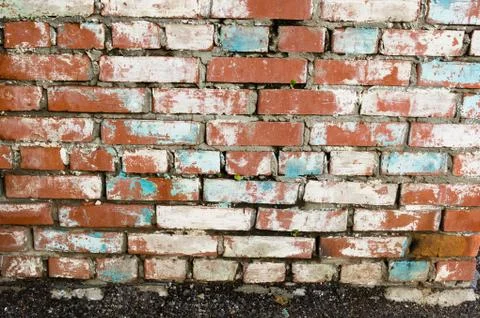 Masonry walls made of red bricks with traces of crumbling plaster Stock Photos