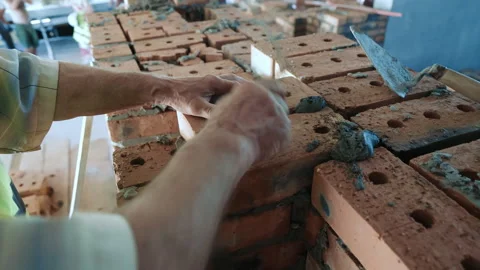 Masonry Work with Bricks and Mortar. A close-up view of a bricklaying process Stock Footage 282383512