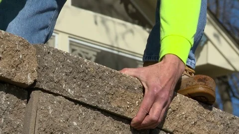 Masonry Worker Installs Stone Bricks by Hand Stock Footage 73583881