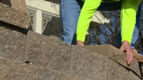 Masonry Workers Install Stone Bricks by Hand Stock Footage 73595405