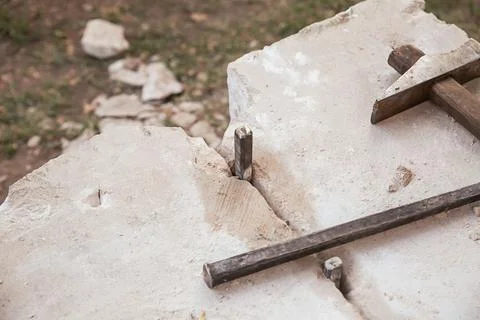 Mason's tool iron chisel and hammer on stone background Stock Photos