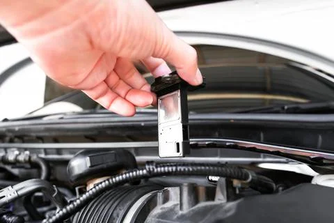 Mass air flow sensor in a hand of air intake manifold in the car engine , A.. Stock Photos