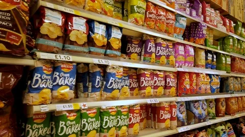 A mass array of processed snack or 'junk' foods on shelf of a British Stock Footage 105377963