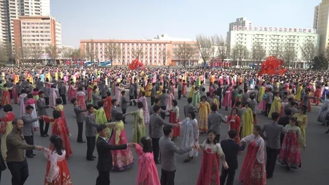 Mass dance at Day of the Sun in Pyongyang in Democratics Peoples Republic Video stock 107284541