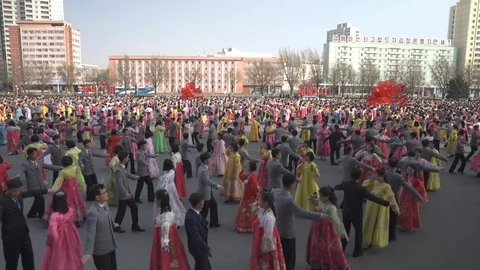 Mass dance at Day of the Sun in Pyongyang in Democratics Peoples Republic Stock Footage 107284641