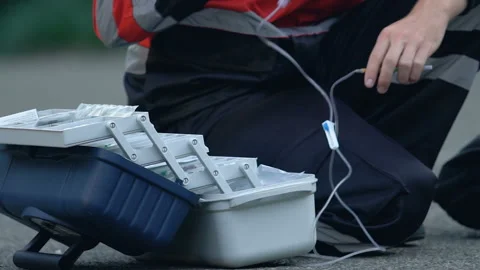 Mass tragedy, paramedics assisting wounded people right on street, emergency Stockbeeldmateriaal 99379704