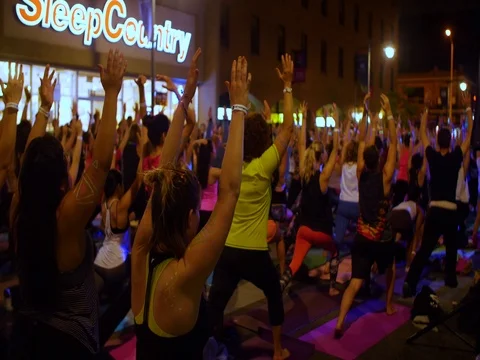 Mass yoga session back view Ottawa 2017 Glowfair. Video stock 76798038