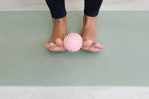Massage ball exercise trains toe alignment, arch control, foot muscles and co Stock Photos