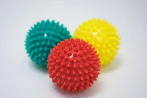 Massage balls. Three different colored balls on a white background. Stock Photos