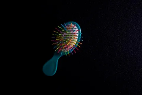 Massage comb on a dark textile. Flat lay and copy s Stock Photos