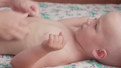 Massage professional therapist does for two years old baby boy child rehabili Stockbeeldmateriaal 111180192