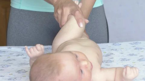 Massage professional therapist does for two month old baby girl child Stockbeeldmateriaal 111277683