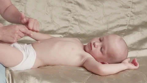 Massage professional therapist does for two years old baby boy child rehabili 스톡 동영상 118450415