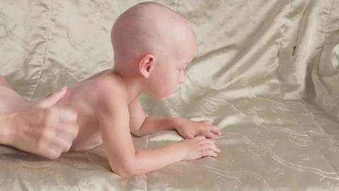 Massage professional therapist does for two years old baby boy child rehabili 스톡 동영상 118450438