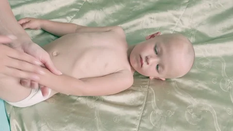 Massage professional therapist does for two years old baby boy child rehabili 스톡 동영상 119064379