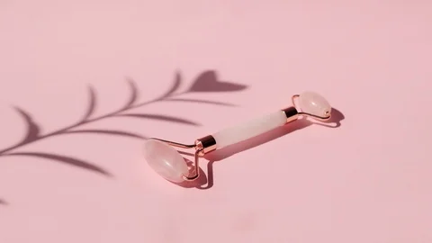 Massage quartz roller for the face of pink natural nephritis. Skin care Stock Footage 128248533