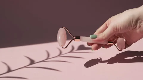 Massage quartz roller for the face of pink natural nephritis. Stock Footage 128248566