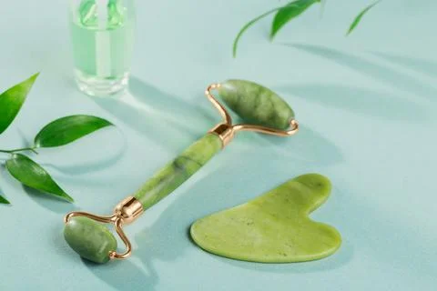 Massage roller for the face with two heads and gua sha scraper Stock Photos
