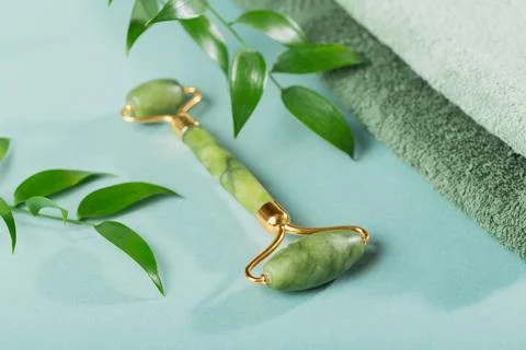 Massage roller for the face with two heads of jade stone Stock Photos